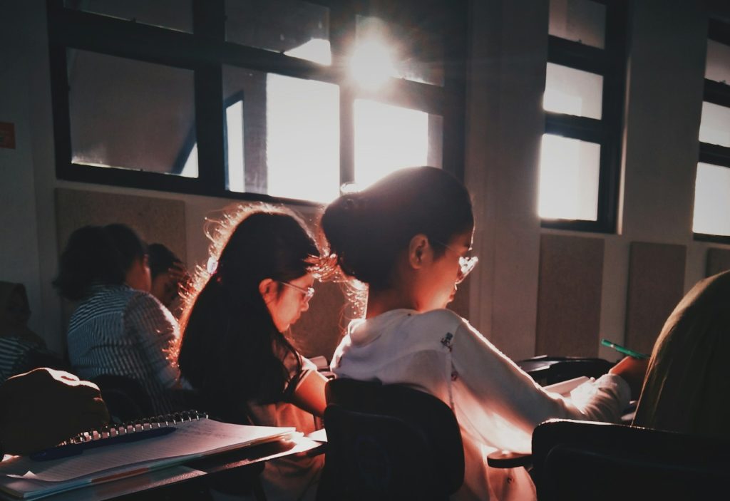 a group of people sitting at desks